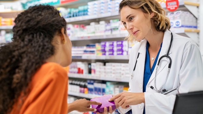 female pharmacist speaking to female patient