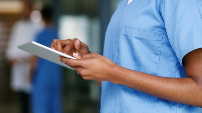 close-up of African American doctor working on a tablet